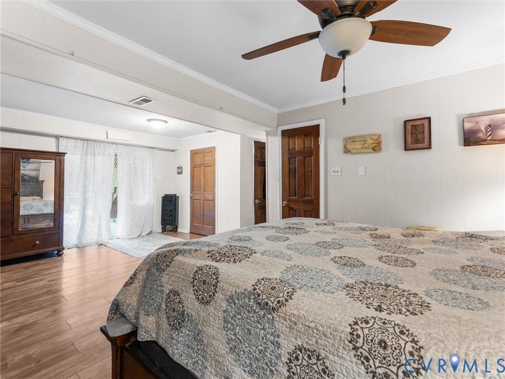 8251 Old Roxbury Road, Quinton, VA 23141 Wood-finish flooring, ceiling fan with integrated lighting, paneled doors with wood finish, and glass-paned sliding doors