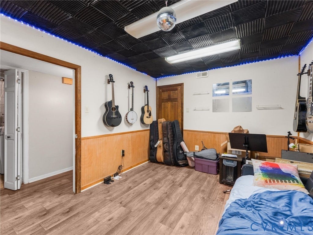 8251 Old Roxbury Road, Quinton, VA 23141 Wood-finish flooring, half-wall wood paneling, sound-dampening acoustic ceiling tiles, and solid wood interior door