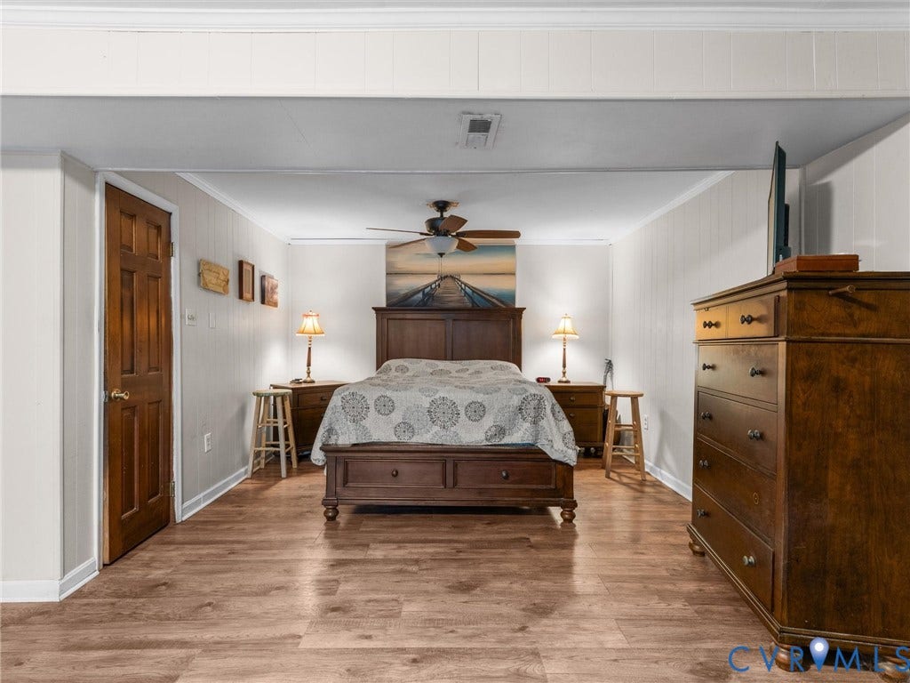 8251 Old Roxbury Road, Quinton, VA 23141 Wood-finish flooring, paneled walls, and a ceiling fan with integrated lighting