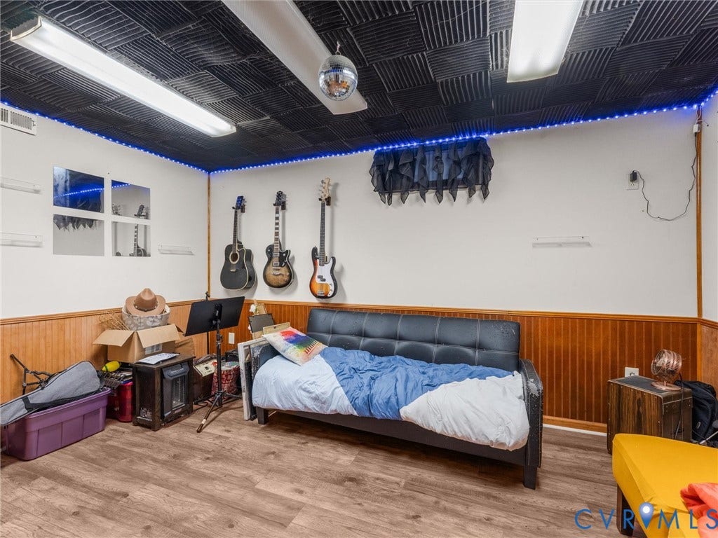 8251 Old Roxbury Road, Quinton, VA 23141 Wood-finish flooring, half-wall wainscoting, black acoustic-tile ceiling, linear recessed lighting, and integrated LED perimeter strip lighting