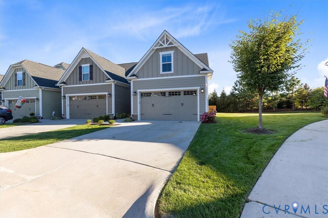 9129 Spring Green Loop, Mechanicsville, VA 23116 Open green space and lush professional landscaping behind townhome for privacy