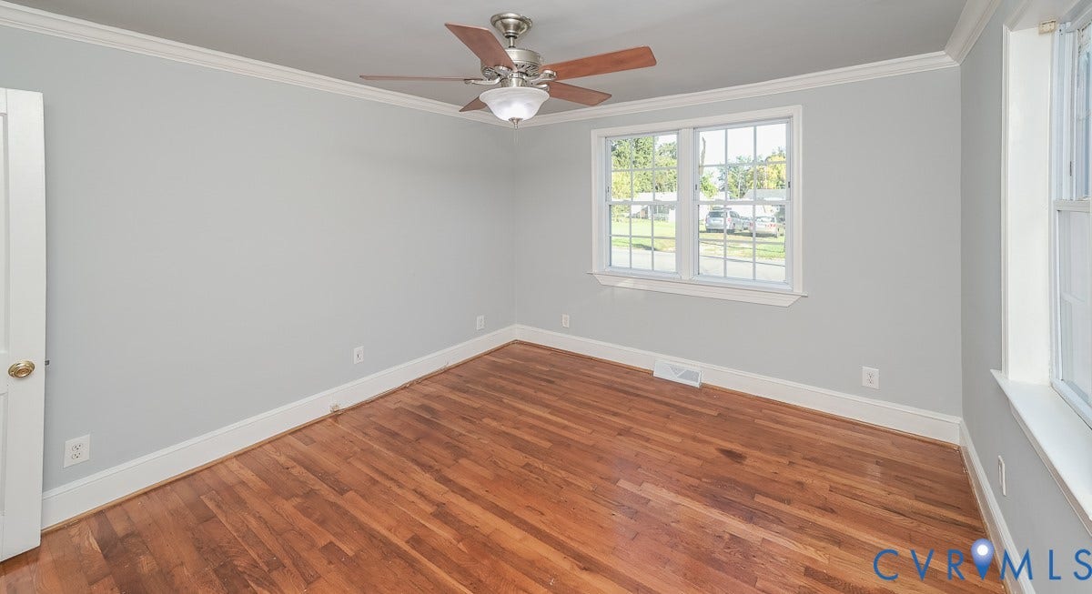 Hardwood flooring, crown molding, ceiling fan, and white window trim