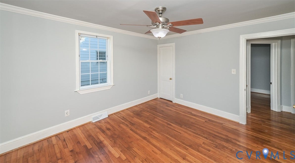 Hardwood flooring, crown molding, ceiling fan with light fixture, single window, and a white interior door