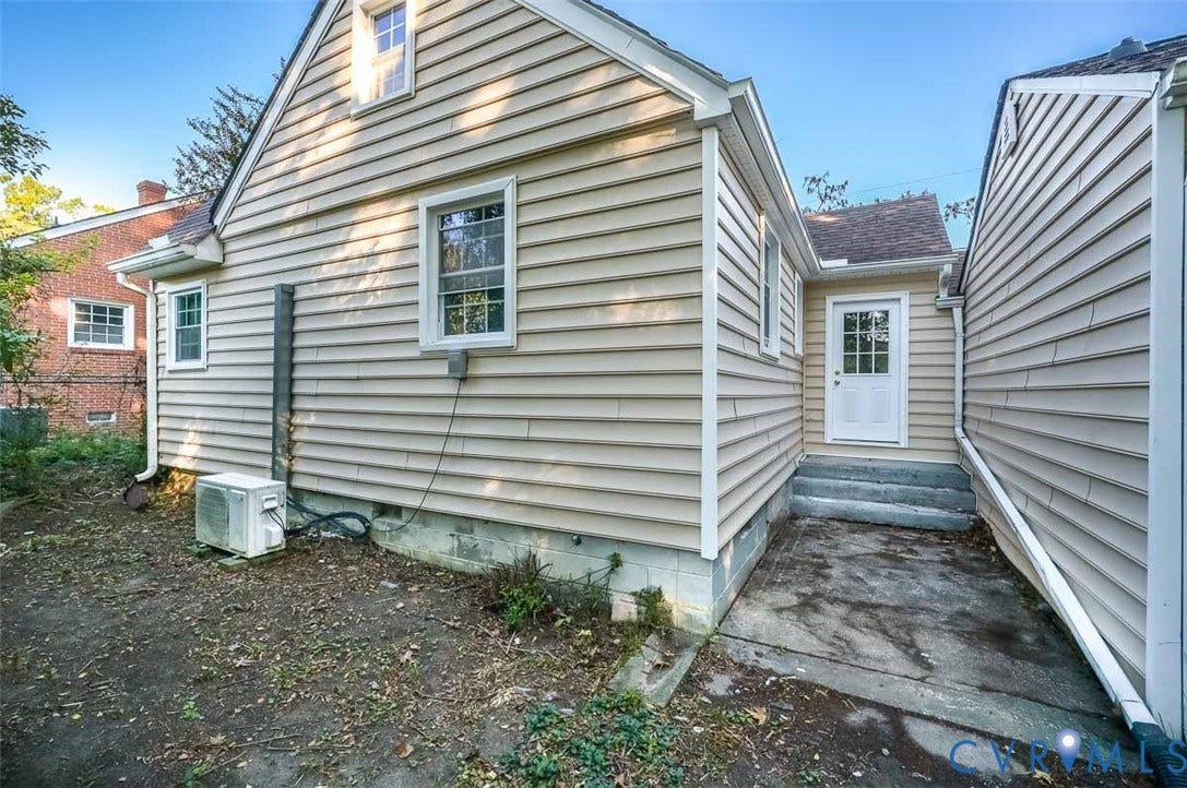 Exterior siding with multiple windows, including a dormer window