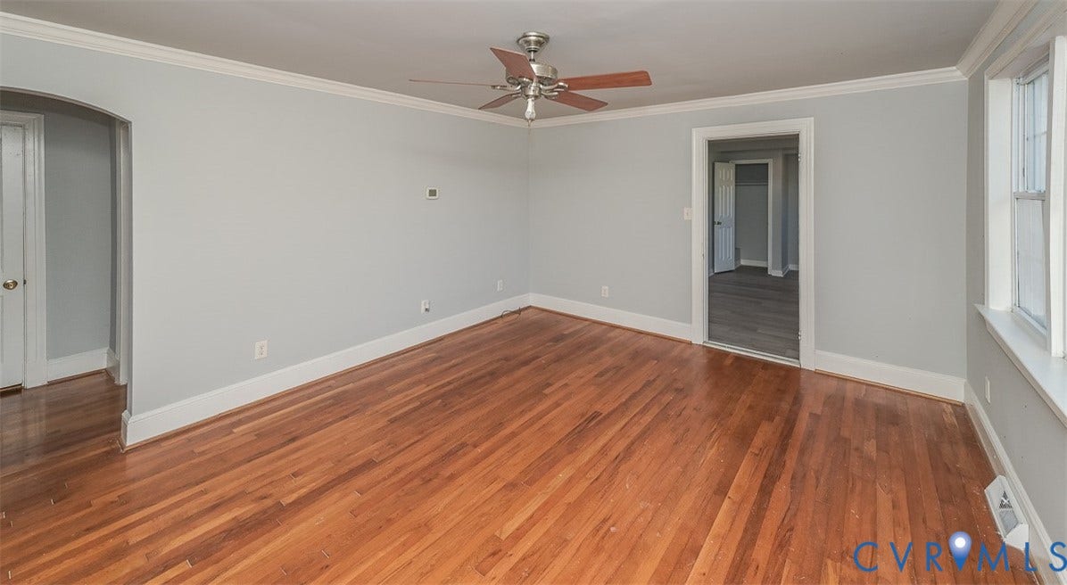 Hardwood flooring, painted walls, crown molding, ceiling fan, and window