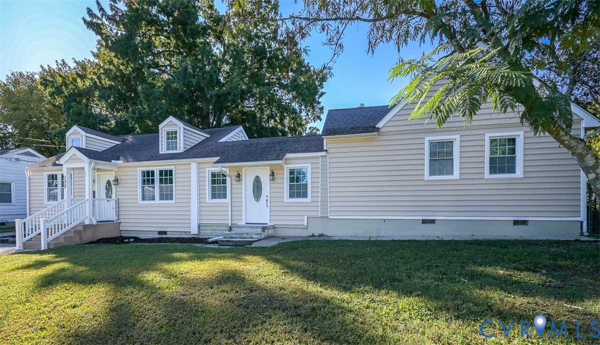 Siding exterior with multiple dormer windows, covered entryways, and white trim accents