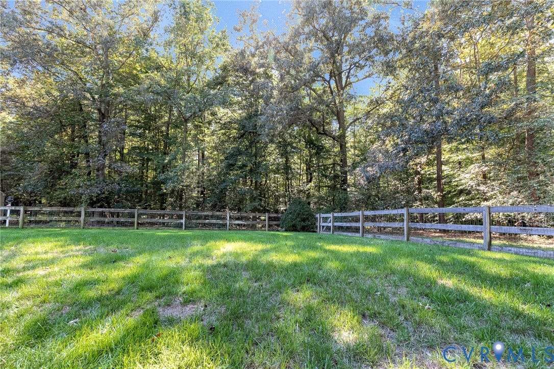 360 Laurel Drive, Aylett, VA 23009 Expansive green lawn with a split-rail fence and mature trees