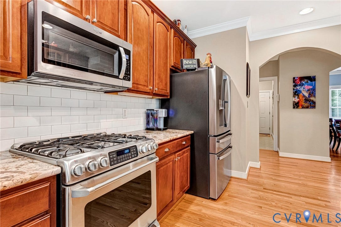 360 Laurel Drive, Aylett, VA 23009 Kitchen featuring wood cabinetry, stainless steel appliances, granite-style countertops, and a white subway tile backsplash