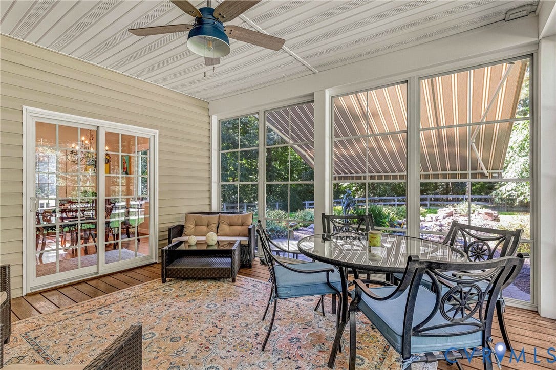 360 Laurel Drive, Aylett, VA 23009 Screened-in porch featuring a ceiling fan, wood-finish flooring, sliding glass doors, and large windows with awnings