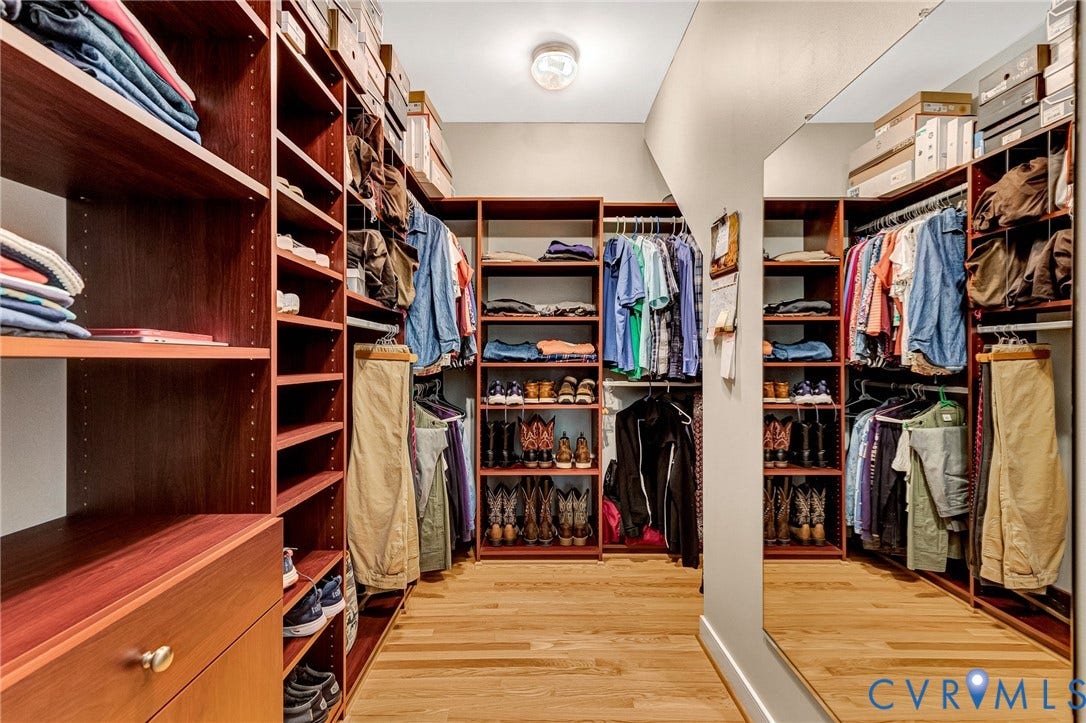 360 Laurel Drive, Aylett, VA 23009 Custom closet system with wood-finish shelving, integrated hanging rods, and pull-out drawers