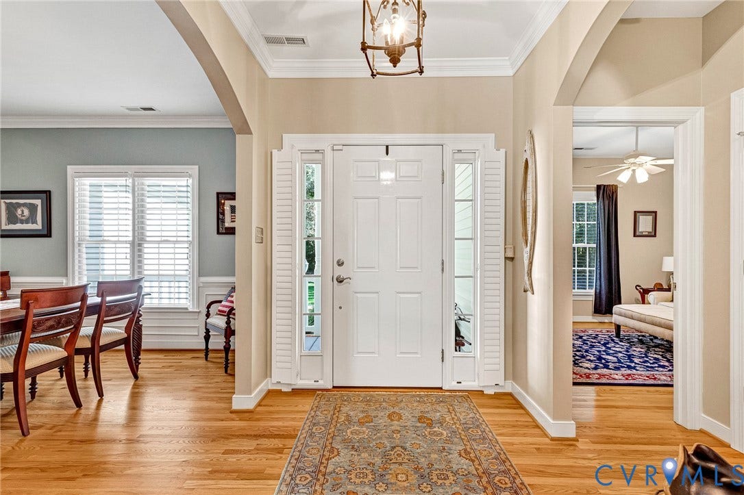 360 Laurel Drive, Aylett, VA 23009 Hardwood flooring throughout the entry and dining space, crown molding, and a paneled front door with sidelights