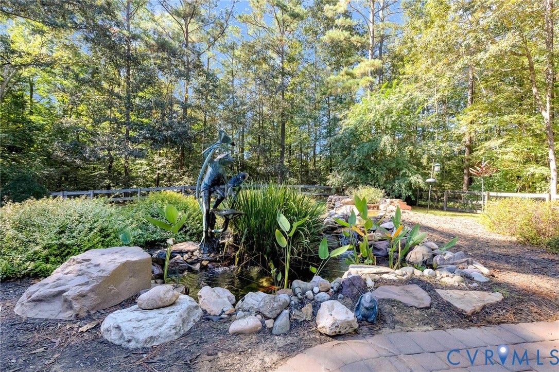 360 Laurel Drive, Aylett, VA 23009 Landscaped outdoor area featuring a water feature, stone accents, and mature trees