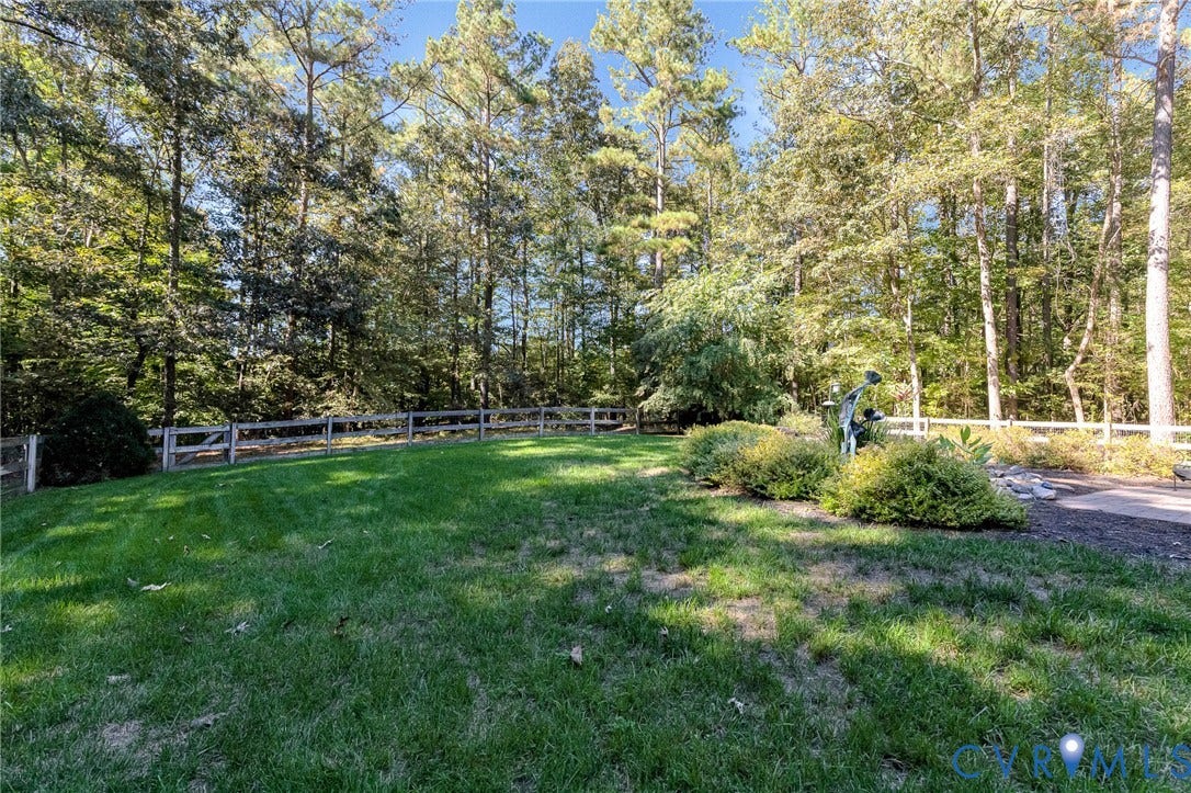 360 Laurel Drive, Aylett, VA 23009 Expansive grounds featuring mature pine and deciduous trees, manicured lawn, and white-painted wooden fencing