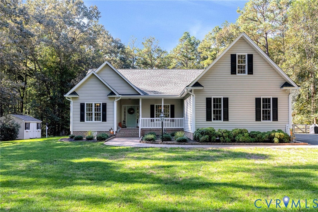 360 Laurel Drive, Aylett, VA 23009 Gabled roofline with light-colored siding and black window shutters