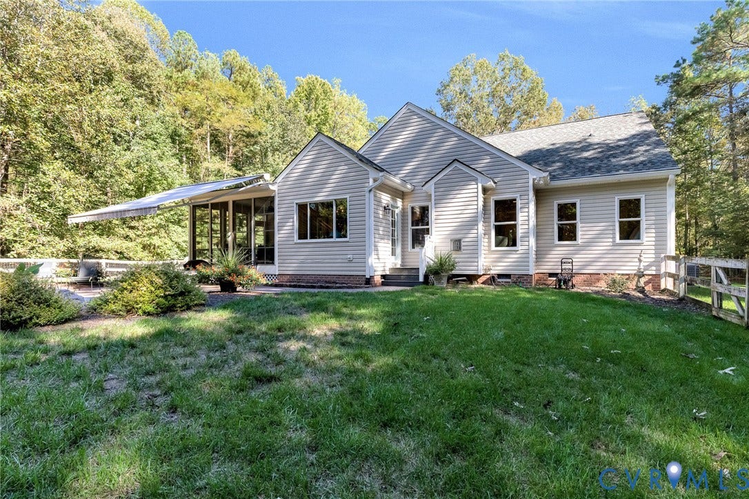360 Laurel Drive, Aylett, VA 23009 Modern farmhouse residence showcasing horizontal siding exterior with a covered front porch entry, multiple windows providing natural light, and a gently sloping roofline