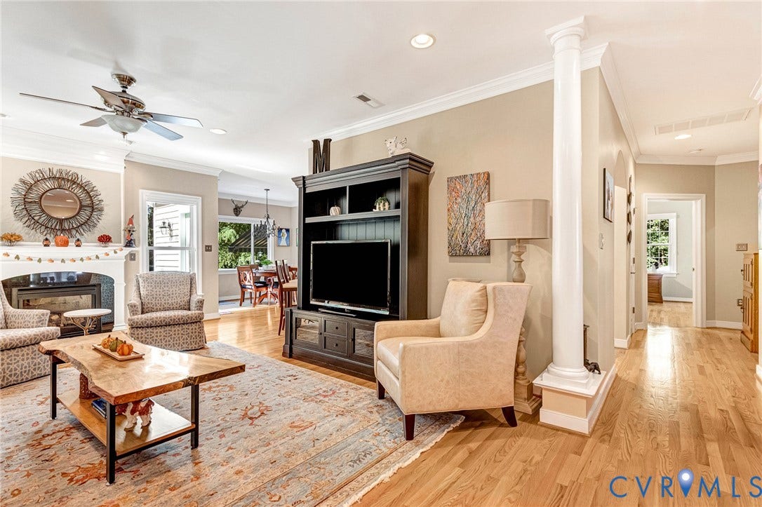 360 Laurel Drive, Aylett, VA 23009 Living area with hardwood flooring, a ceiling fan, crown molding, and a built-in fireplace