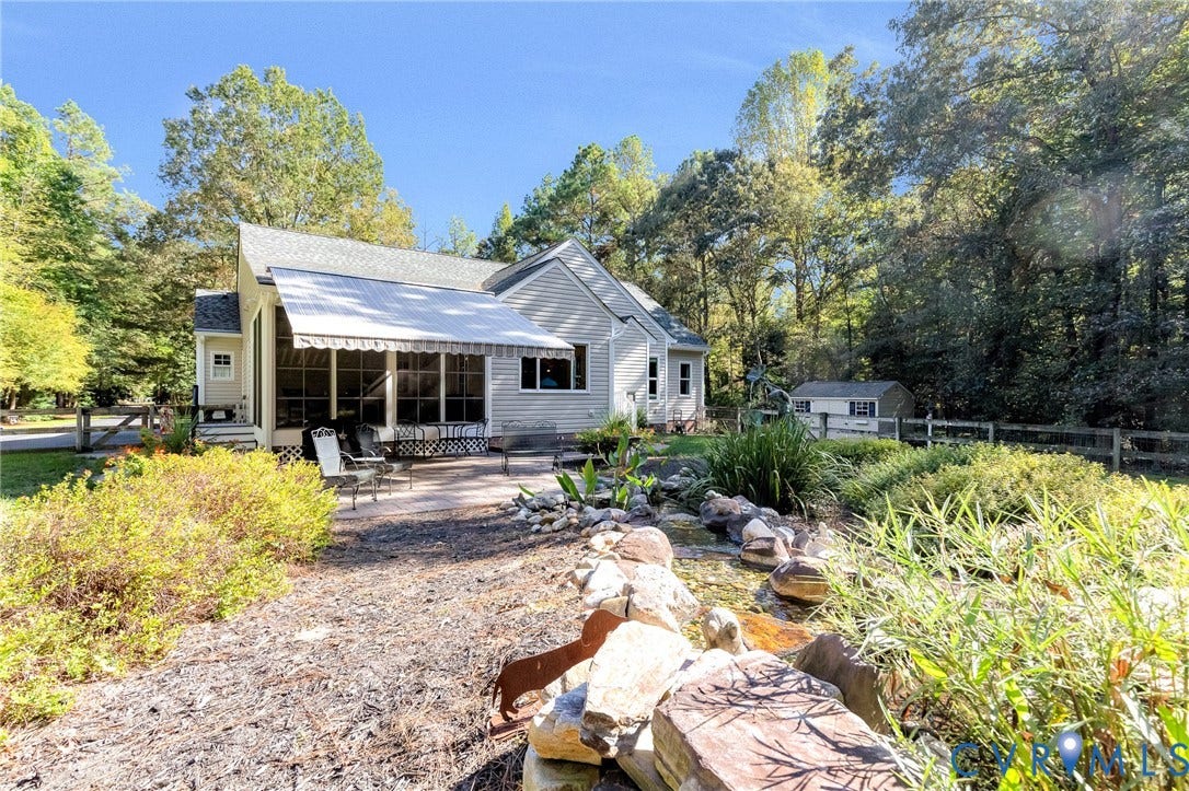 360 Laurel Drive, Aylett, VA 23009 Exterior featuring a screened porch, retractable awning, outdoor patio, established landscaping, and a detached shed