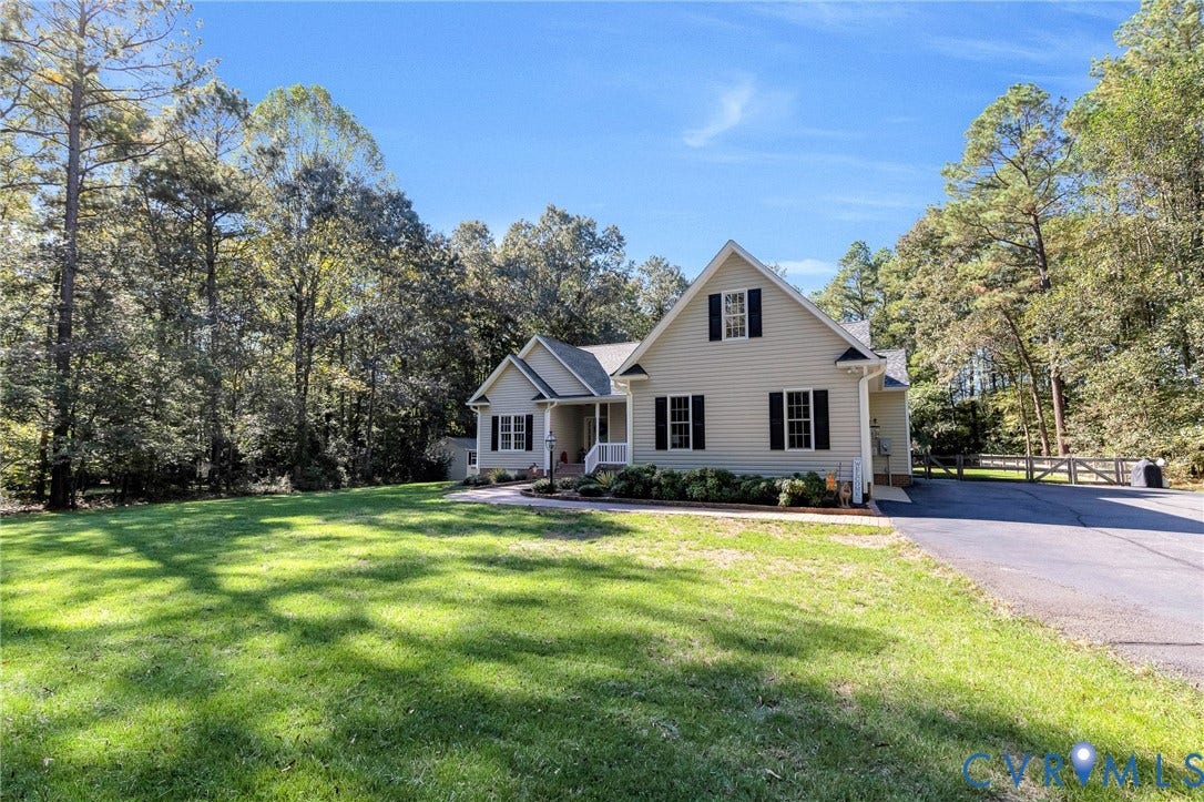 360 Laurel Drive, Aylett, VA 23009 Gable-roofed home with light-colored siding and black window shutters