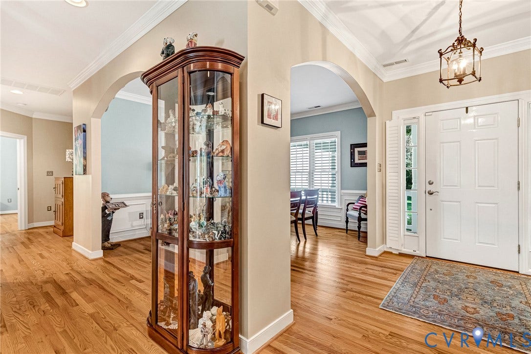 360 Laurel Drive, Aylett, VA 23009 Hardwood flooring, arched doorways, crown molding, paneled front door, and a built-in display cabinet
