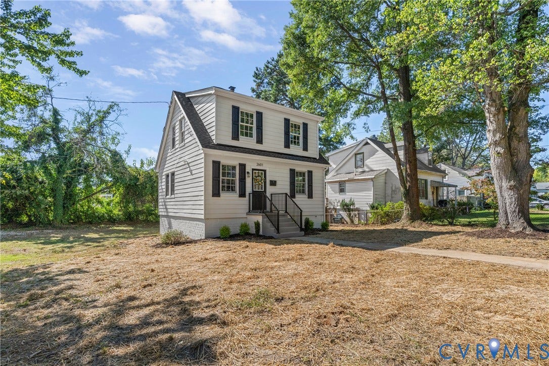 2601 Greenway Avenue, Lakeside, Henrico, VA 23228 Two-story exterior featuring white horizontal siding, black window shutters, a covered entryway with metal railing, and a brick-foundation base