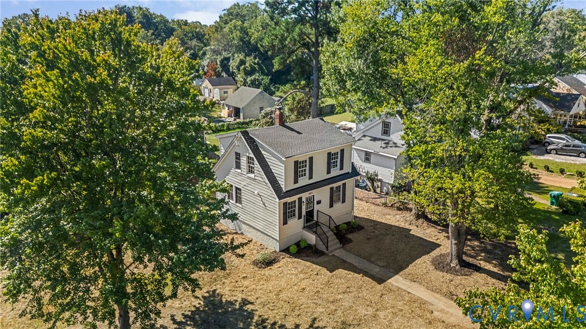 2601 Greenway Avenue, Lakeside, Henrico, VA 23228 Two-story residence featuring light-toned horizontal siding, a pitched shingle roof, dark window shutters, and a front exterior staircase with metal railing