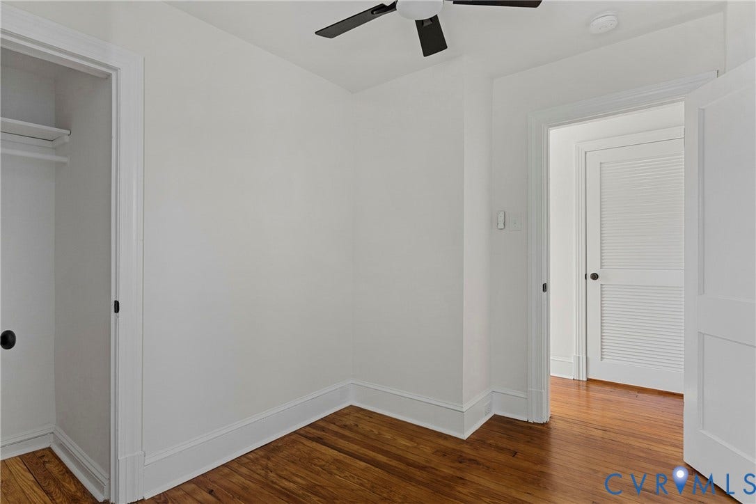 2601 Greenway Avenue, Lakeside, Henrico, VA 23228 Room featuring wood-finish flooring, a matte black ceiling fan, and a built-in closet with shelving
