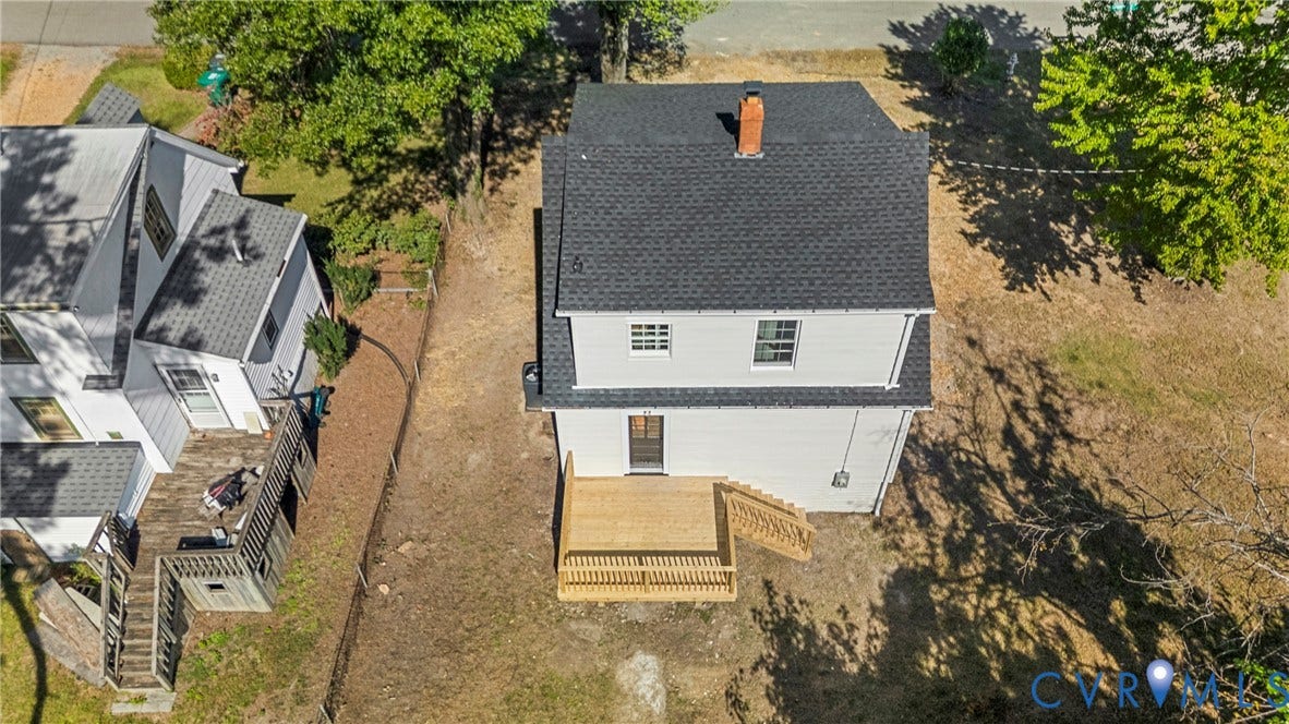 2601 Greenway Avenue, Lakeside, Henrico, VA 23228 Two-story residence featuring a white exterior, dark shingle roof, central brick chimney, and a wooden deck with stairs