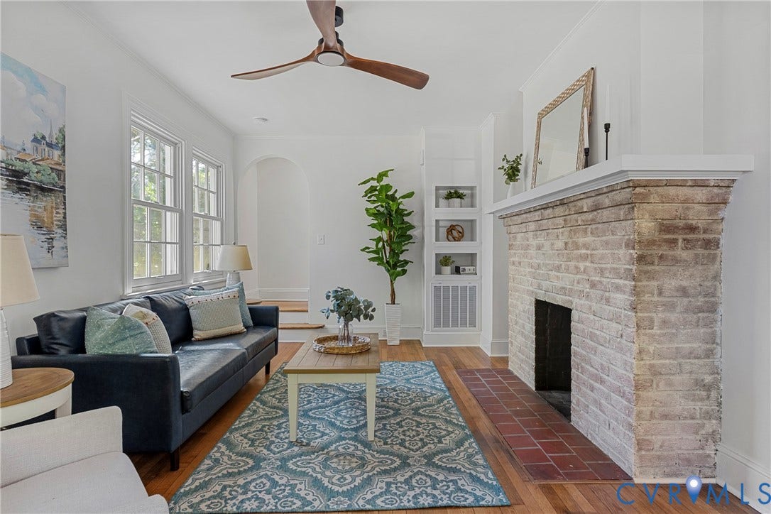 2601 Greenway Avenue, Lakeside, Henrico, VA 23228 Living area featuring wood-finish flooring, a brick fireplace with a raised hearth, built-in shelving, an arched entryway, and a ceiling fan