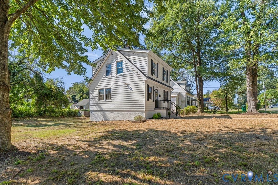 2601 Greenway Avenue, Lakeside, Henrico, VA 23228 Two-story exterior featuring white horizontal siding, dark window shutters, a side-gable roofline, and mature trees on the grounds
