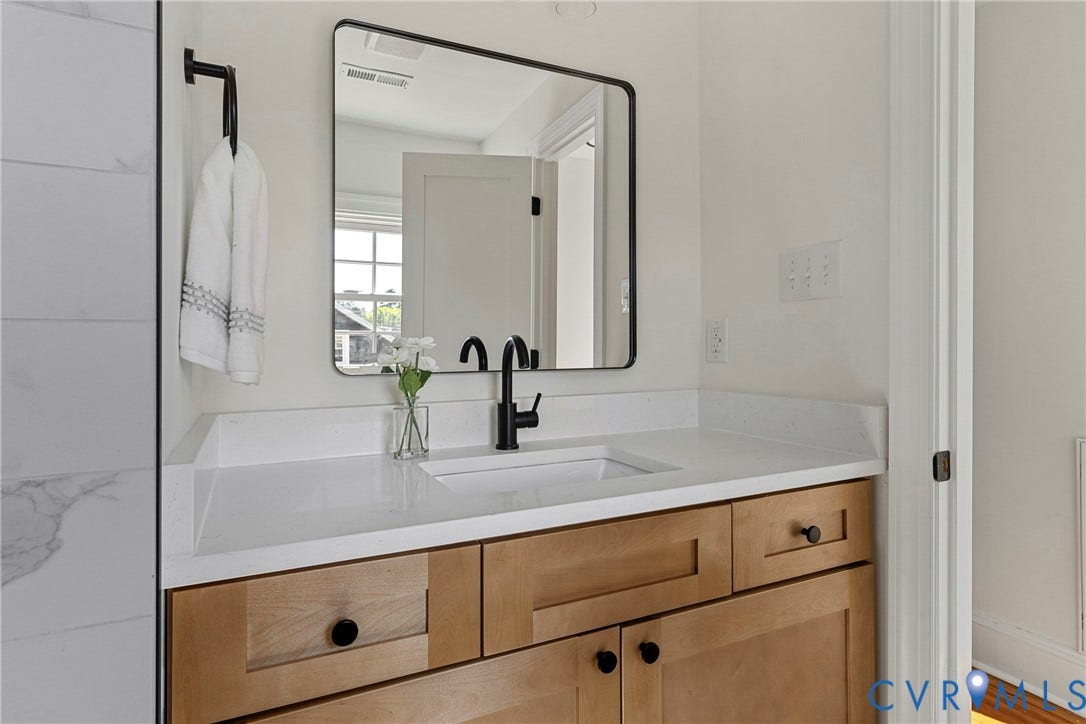 2601 Greenway Avenue, Lakeside, Henrico, VA 23228 Vanity with shaker-style wood cabinetry, white stone countertop, rectangular undermount sink, matte black faucet, and rounded-corner mirror