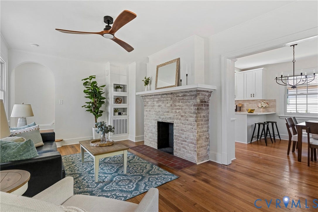 2601 Greenway Avenue, Lakeside, Henrico, VA 23228 Living area featuring wood-finish flooring, a brick fireplace with a mantel, built-in shelving, an arched doorway, and a three-blade ceiling fan