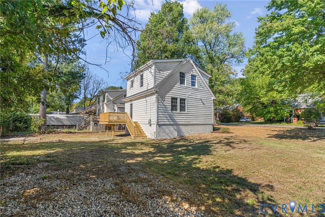 2601 Greenway Avenue, Lakeside, Henrico, VA 23228 Exterior featuring light-toned horizontal siding, a raised wood deck with staircase, and a large lot with mature trees
