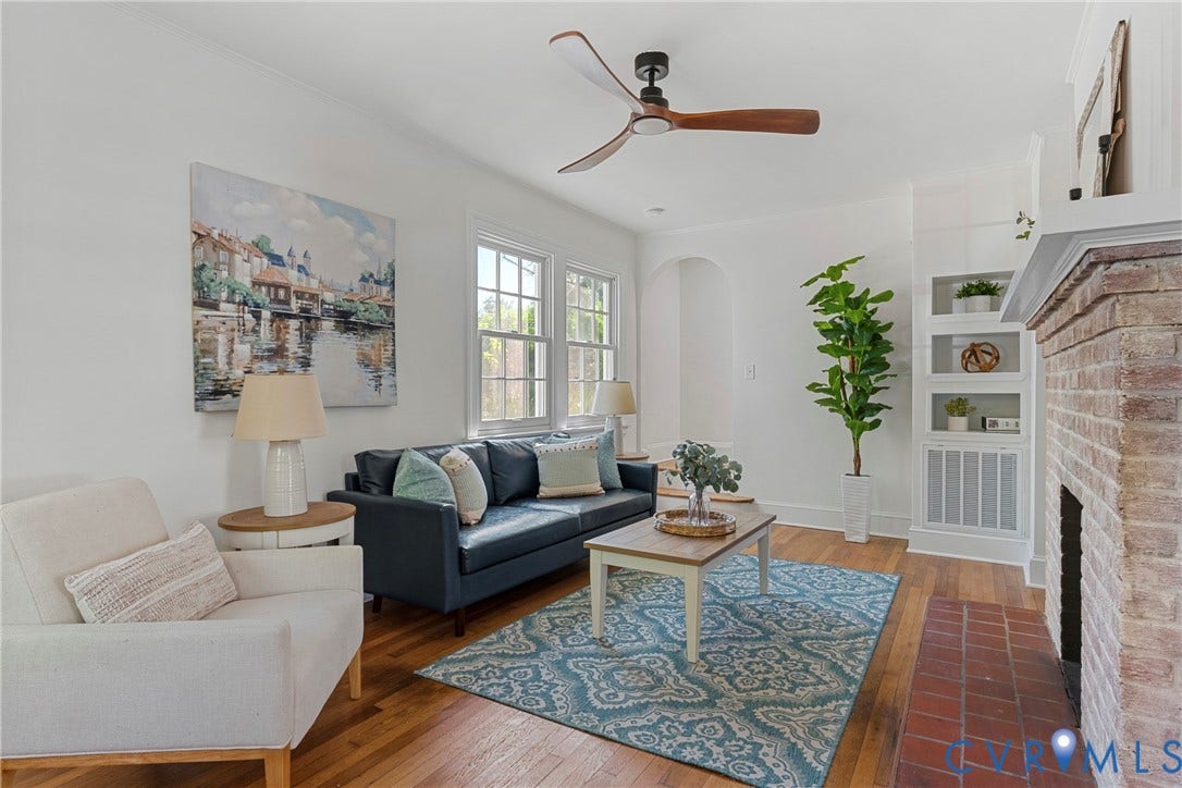 2601 Greenway Avenue, Lakeside, Henrico, VA 23228 Living room featuring wood flooring, a brick fireplace with a red tile hearth, built-in shelving, multi-pane windows, and a ceiling fan