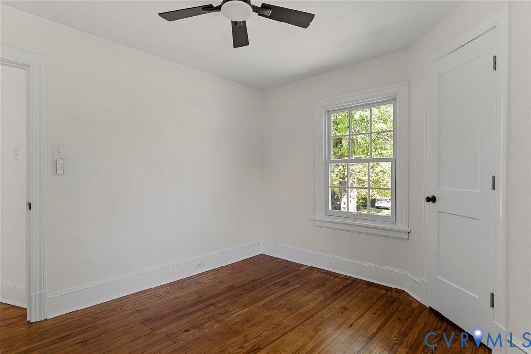 2601 Greenway Avenue, Lakeside, Henrico, VA 23228 Wood-finish flooring, multi-pane window, solid-core panel door with matte black hardware, and ceiling-mounted fan with matte black finish