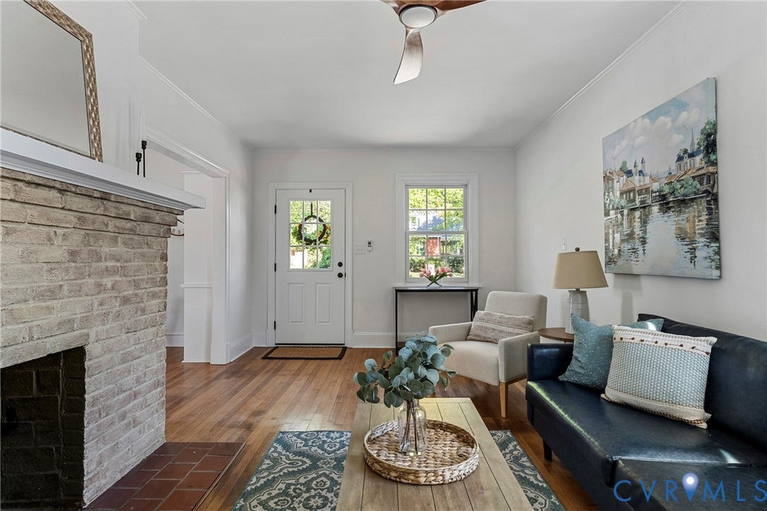 2601 Greenway Avenue, Lakeside, Henrico, VA 23228 Living area featuring wood-finish flooring, a light-toned brick fireplace with a mantel, a multi-pane front entry door, and a ceiling fan with integrated lighting