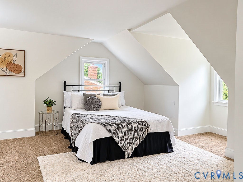 Sloped ceilings with recessed windows, carpeted flooring, and white trim