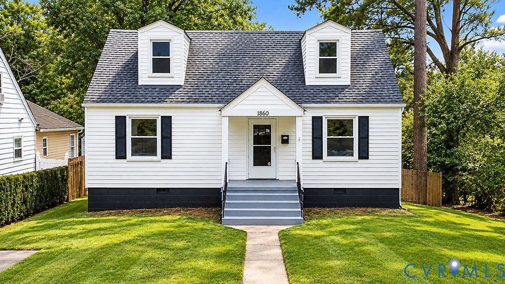 White siding exterior with black shutters and a dark gray shingle roof