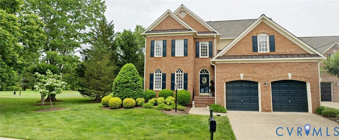 12126 Club Commons Drive, Club Commons, Glen Allen, VA 23059 Brick facade residence featuring two attached garages, a concrete driveway, and a landscaped front yard with mature trees