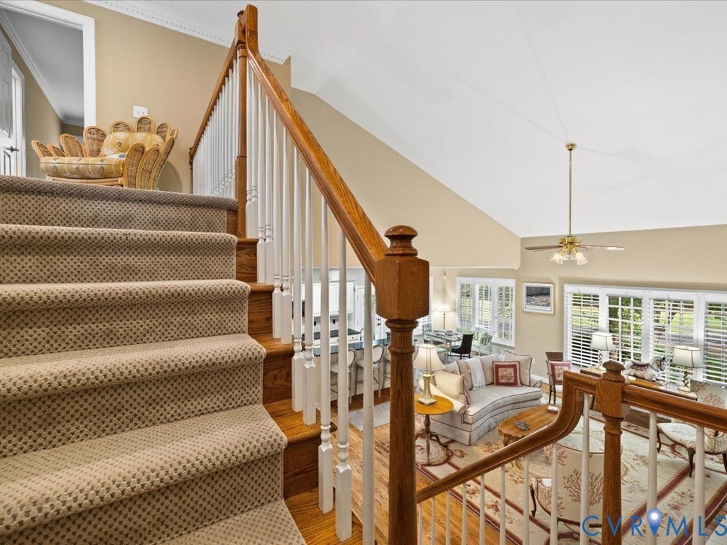12126 Club Commons Drive, Club Commons, Glen Allen, VA 23059 Carpeted staircase with wood handrail, open concept living area, vaulted ceiling, and ample natural light through multiple windows