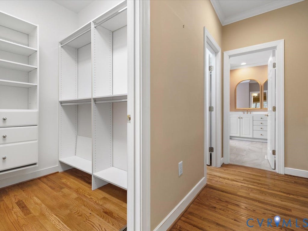 12126 Club Commons Drive, Club Commons, Glen Allen, VA 23059 Hardwood flooring, custom closet shelving, built-in closet drawers, arched mirrors, and white vanity cabinetry