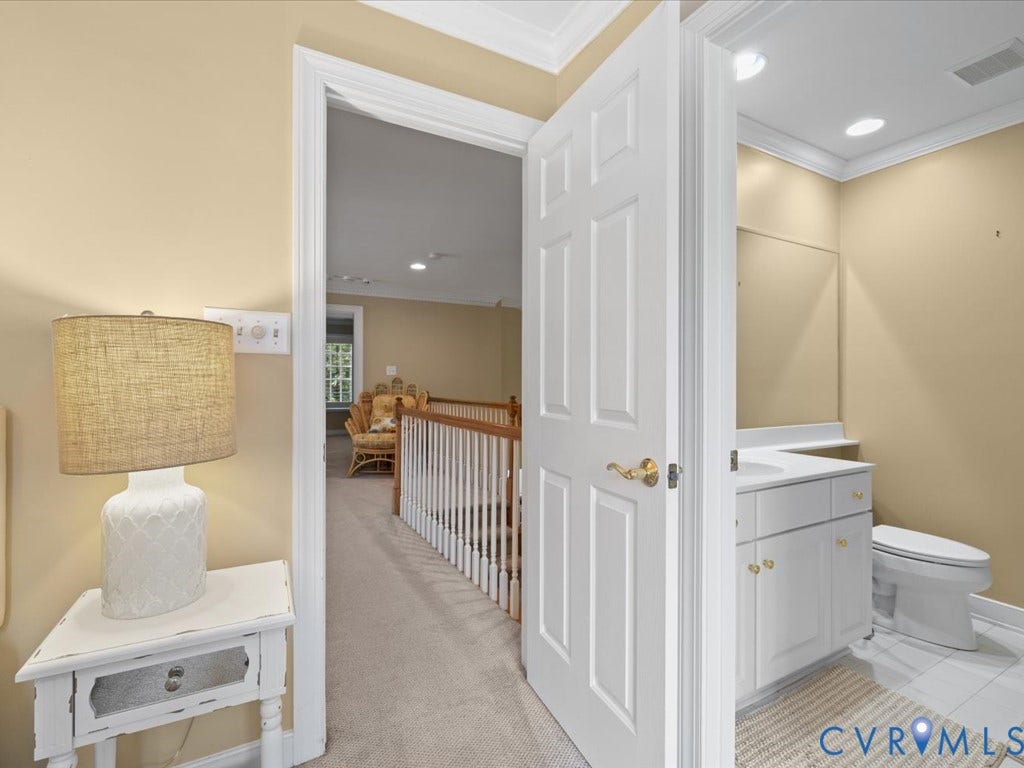 12126 Club Commons Drive, Club Commons, Glen Allen, VA 23059 White panel door with brass hardware, white vanity with integrated sink, white toilet, and recessed lighting