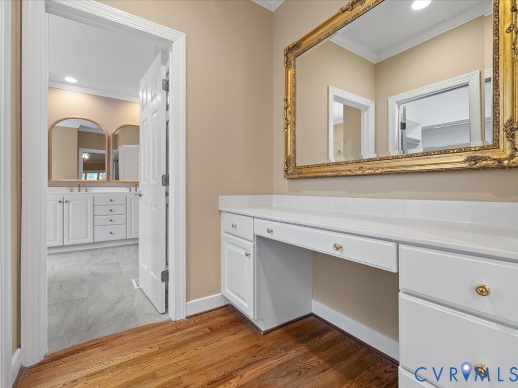 12126 Club Commons Drive, Club Commons, Glen Allen, VA 23059 Hardwood flooring throughout, built-in vanity with white cabinetry and gold hardware, and a large ornate wall mirror