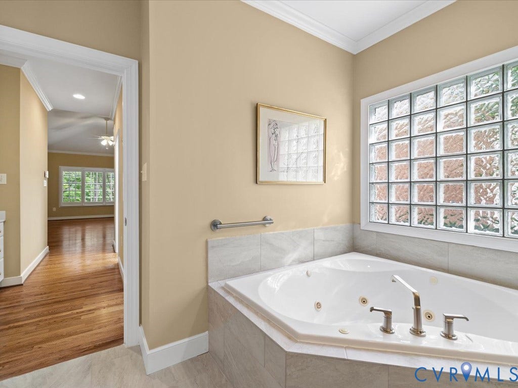 12126 Club Commons Drive, Club Commons, Glen Allen, VA 23059 Jetted soaking tub with a tiled surround, glass block window, and brushed nickel fixtures