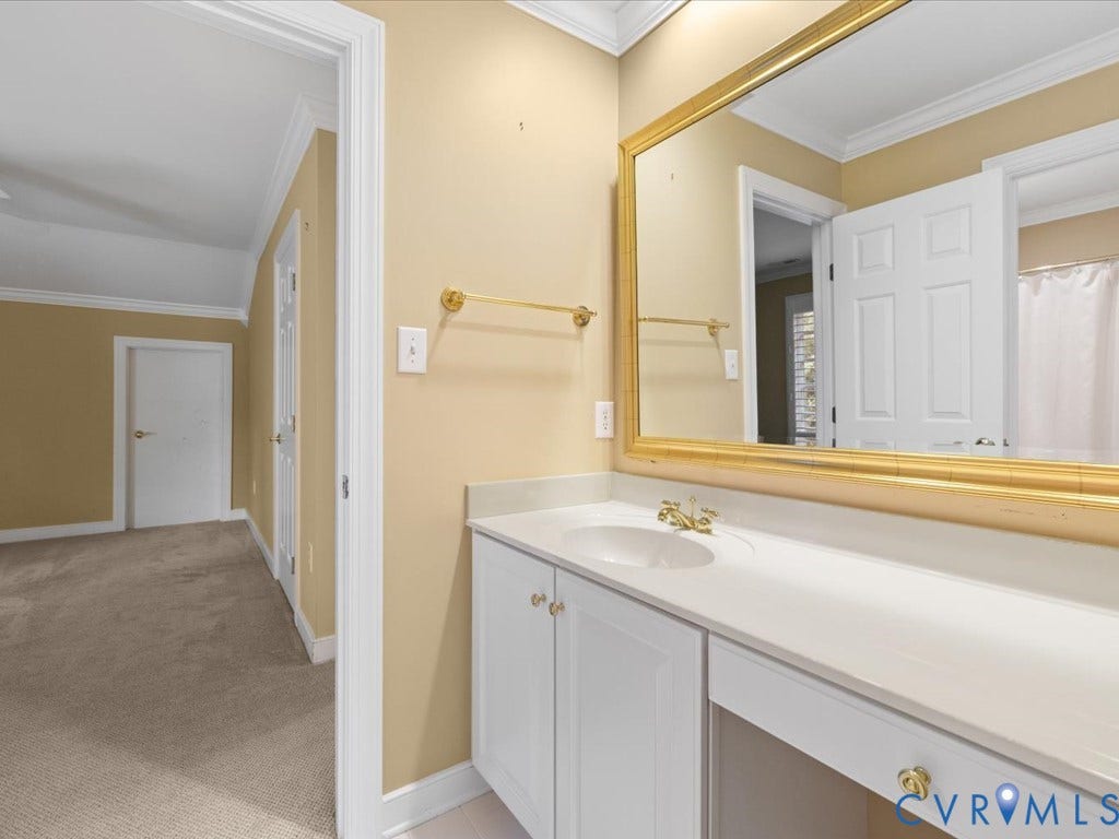 12126 Club Commons Drive, Club Commons, Glen Allen, VA 23059 Vanity with an integrated sink, white cabinetry, gold-finish hardware, and an expansive wall-mounted mirror