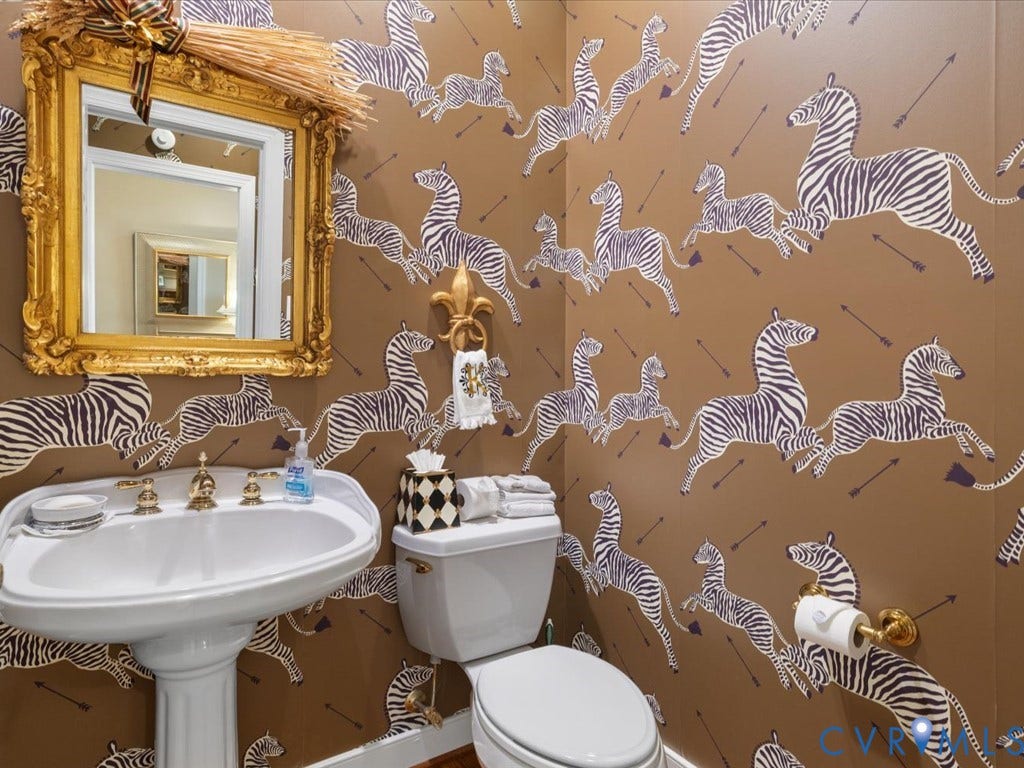 12126 Club Commons Drive, Club Commons, Glen Allen, VA 23059 Pedestal sink with brass-finish faucet, toilet with matching brass-finish toilet paper holder, ornate gold-finish framed mirror, and distinctive patterned wallpaper
