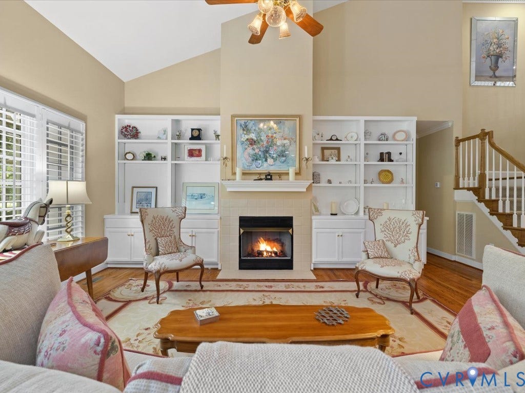 12126 Club Commons Drive, Club Commons, Glen Allen, VA 23059 Vaulted ceiling with a ceiling fan light fixture, integrated built-in shelving, fireplace with a mantel, and wood flooring