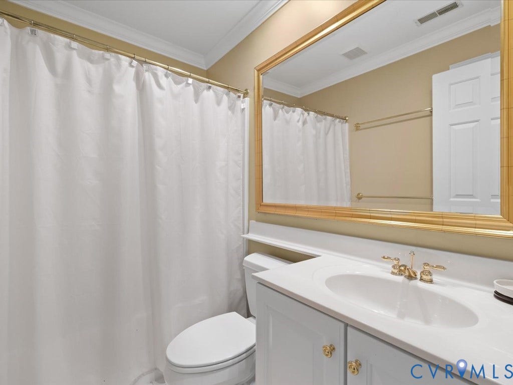 12126 Club Commons Drive, Club Commons, Glen Allen, VA 23059 Bathroom featuring a single vanity, undermount sink, gold-tone hardware, and a framed mirror