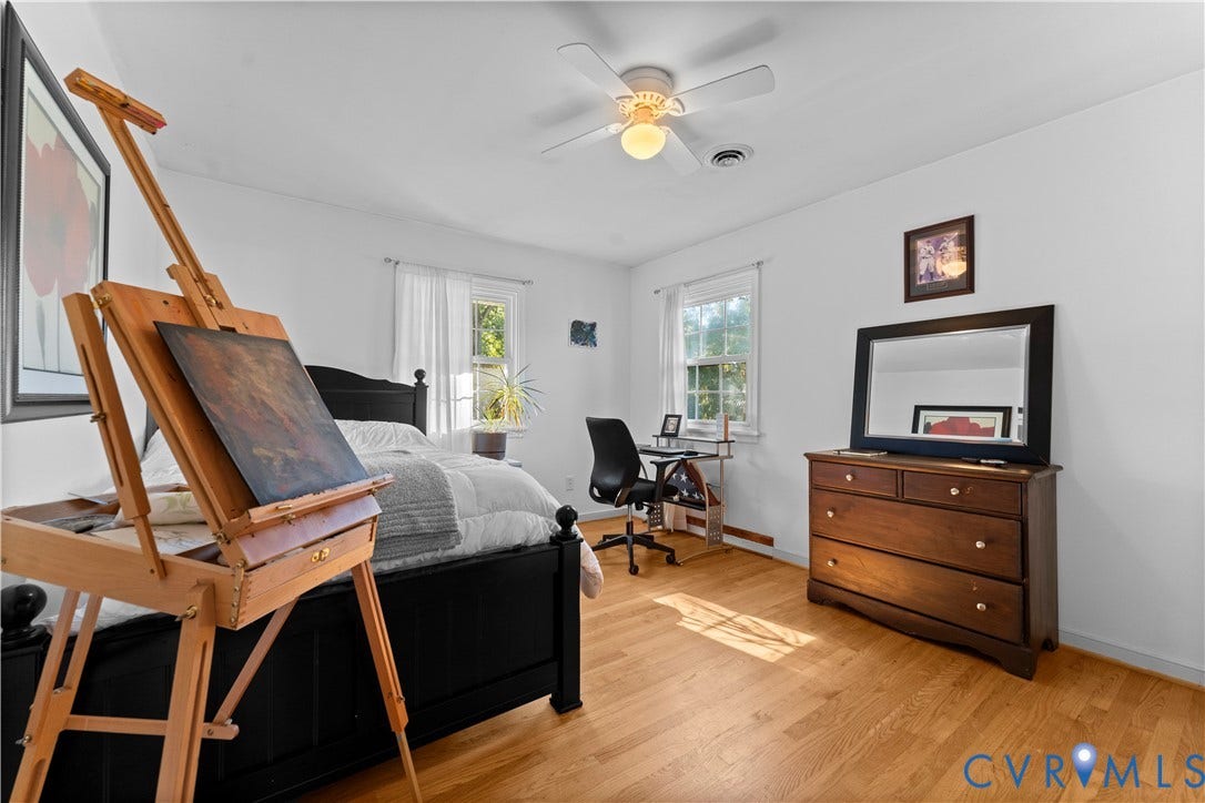 109 Webster Road, Sandston, VA 23150 Hardwood flooring, two windows with natural light, white ceiling fan with light fixture, built-in dresser, and white walls