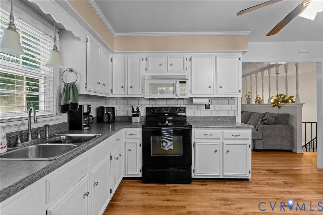 109 Webster Road, Sandston, VA 23150 Kitchen featuring white cabinetry, a double basin stainless steel sink, black electric range, and wood-finish flooring