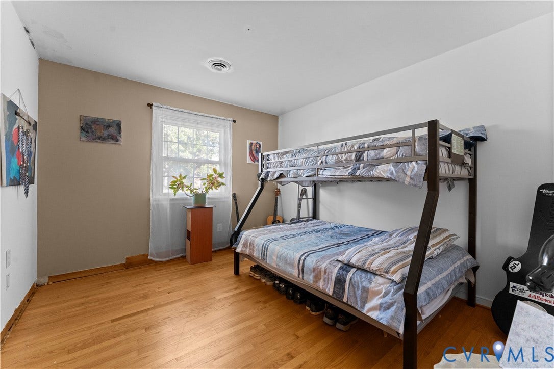 109 Webster Road, Sandston, VA 23150 Hardwood flooring, painted walls, and a window with natural light
